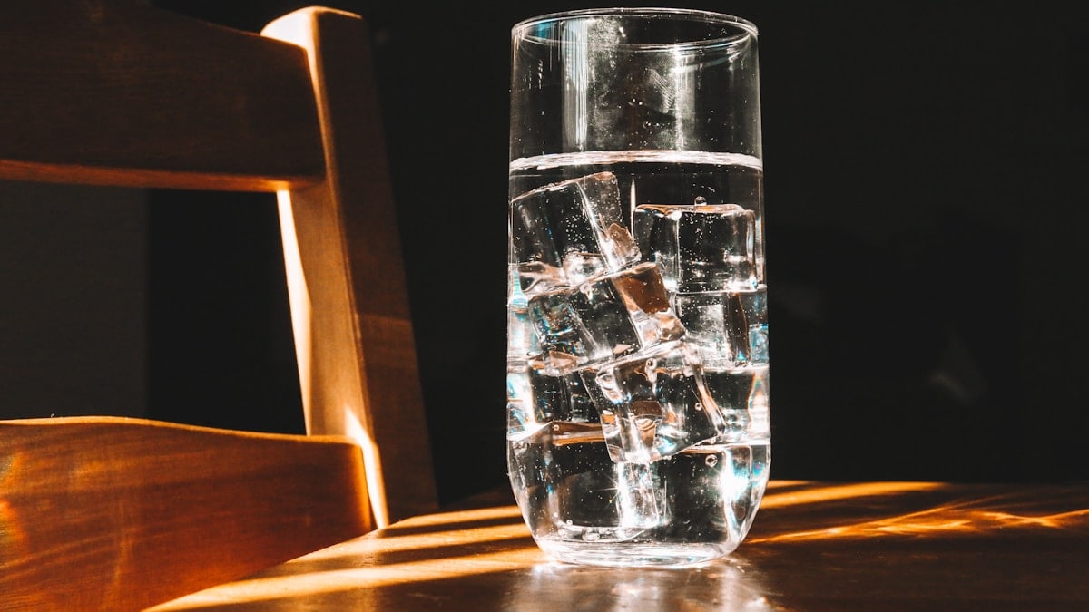 clear drinking glass on brown wooden table
